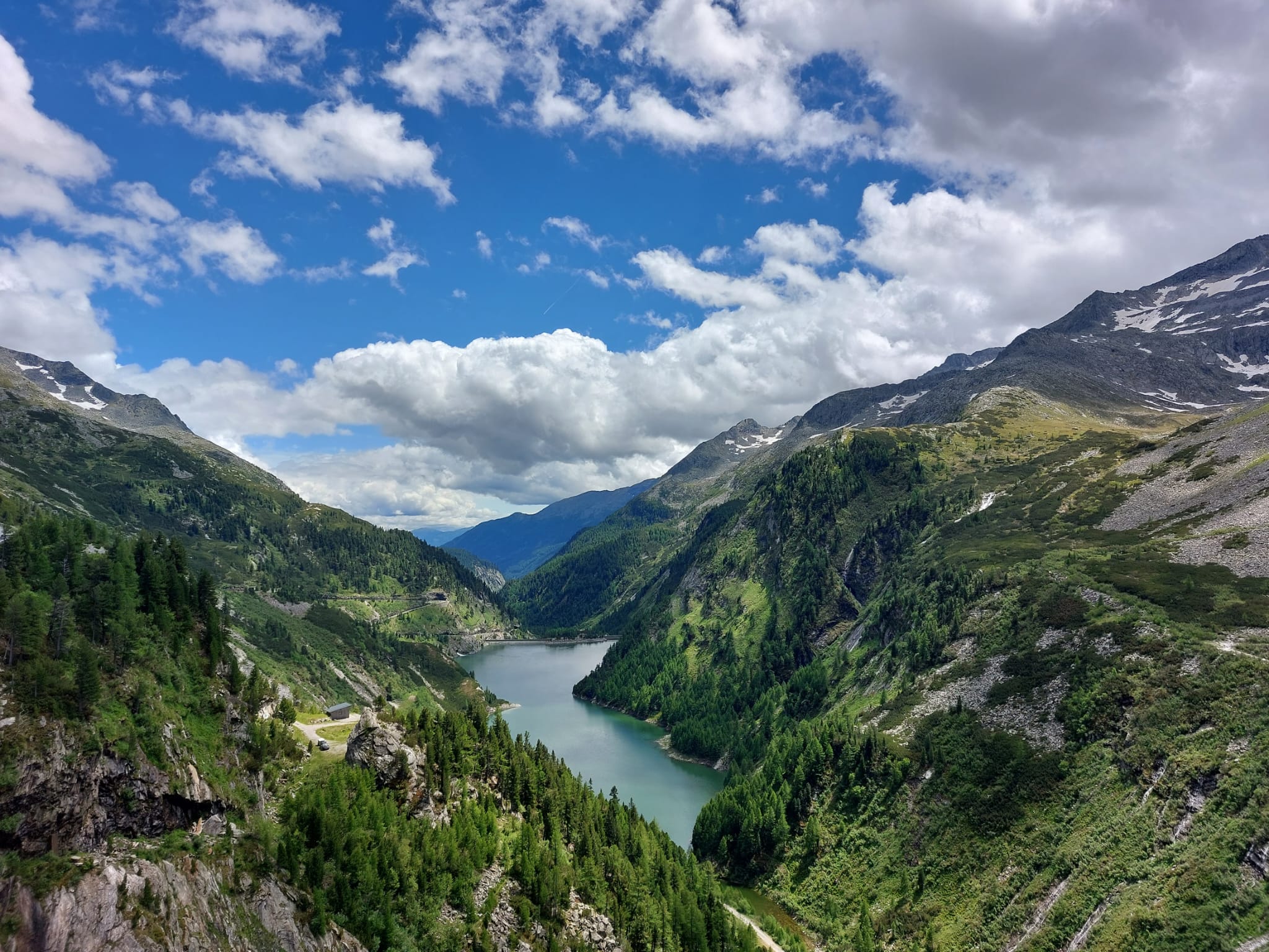 Bergsee im Hintergrund blauer Himmel mit ein paar Wolken